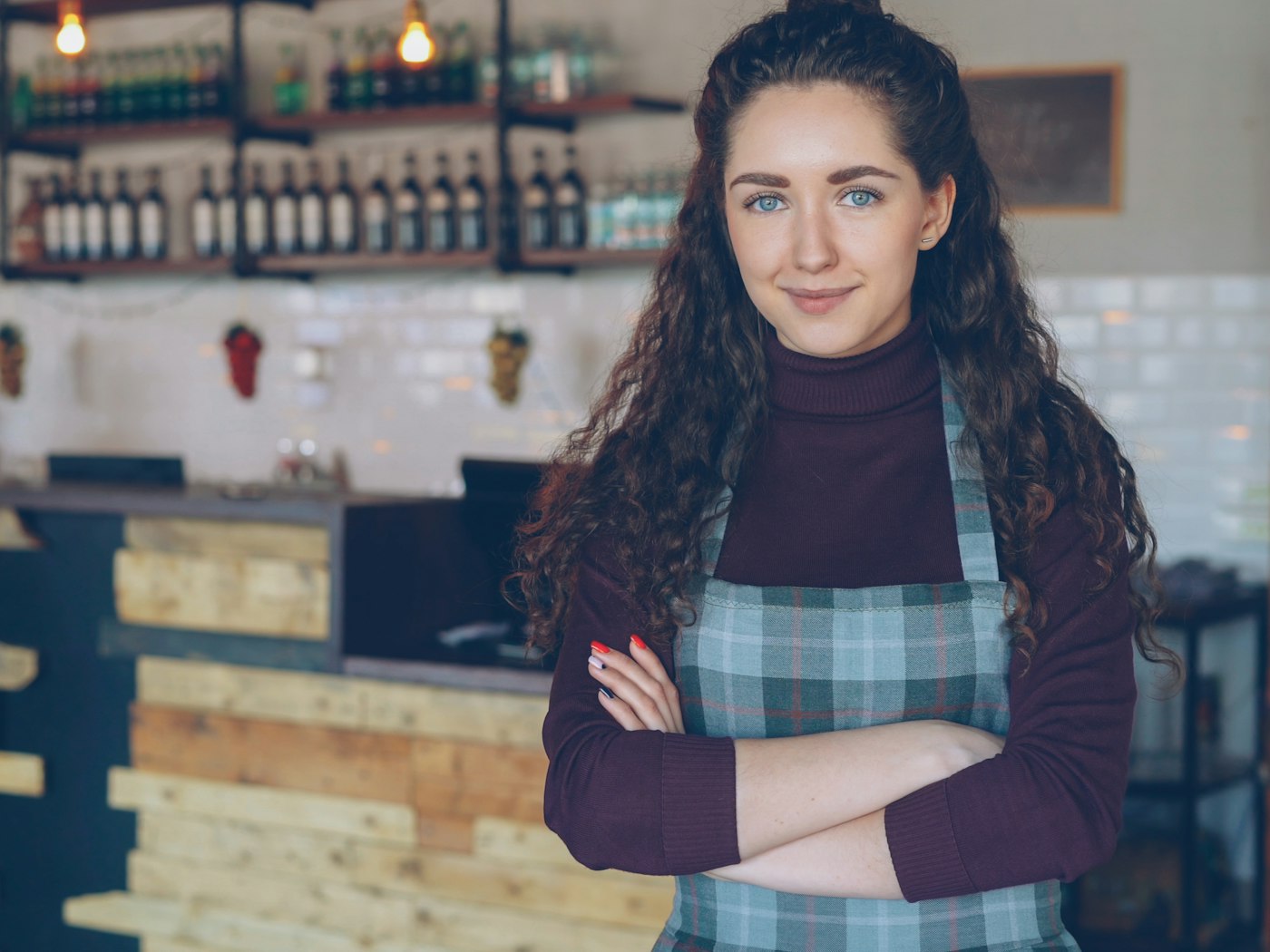 Café owner standing behind her counter